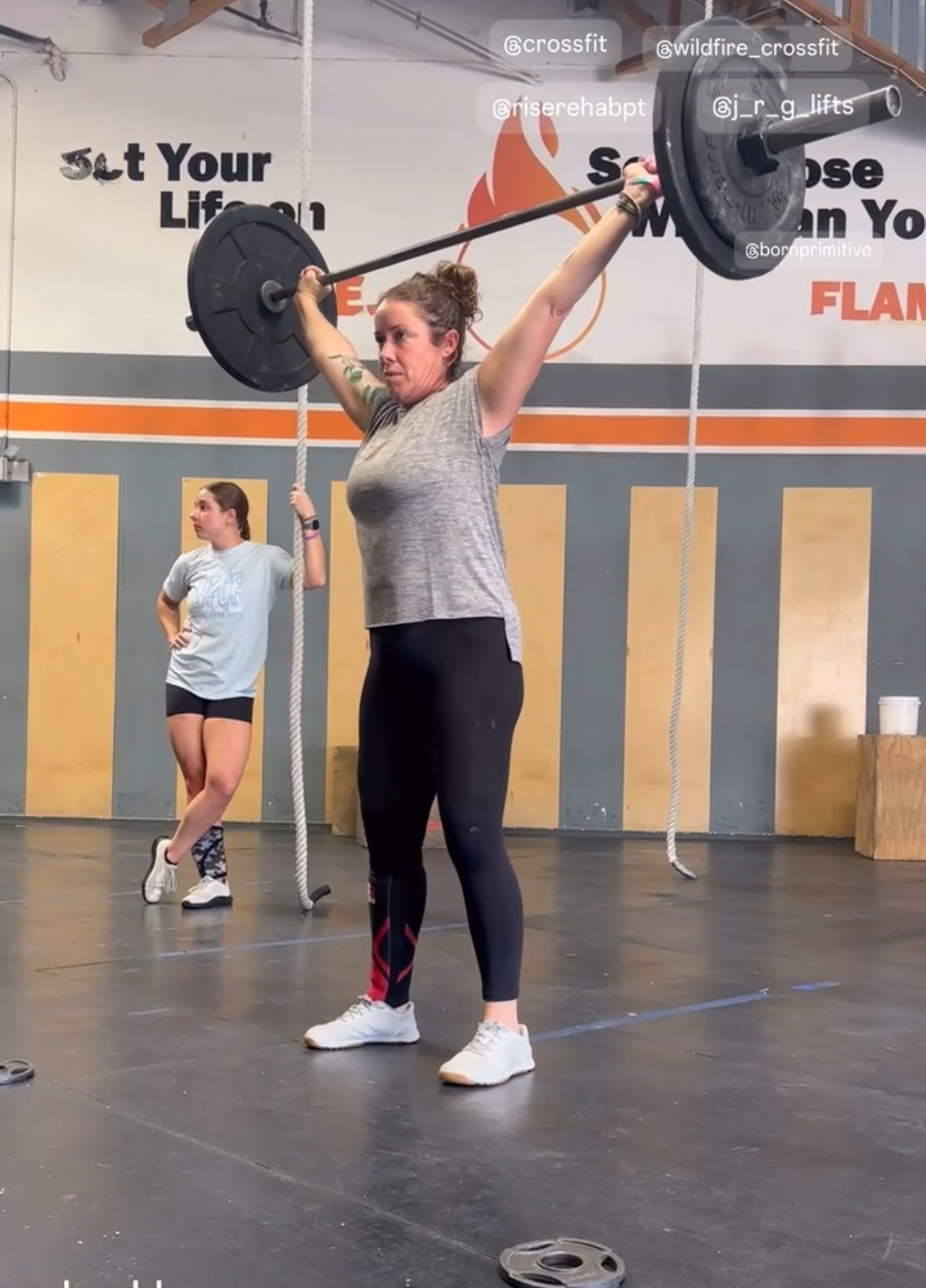 Barbell overhead from a snatch lift at a CrossFit gym